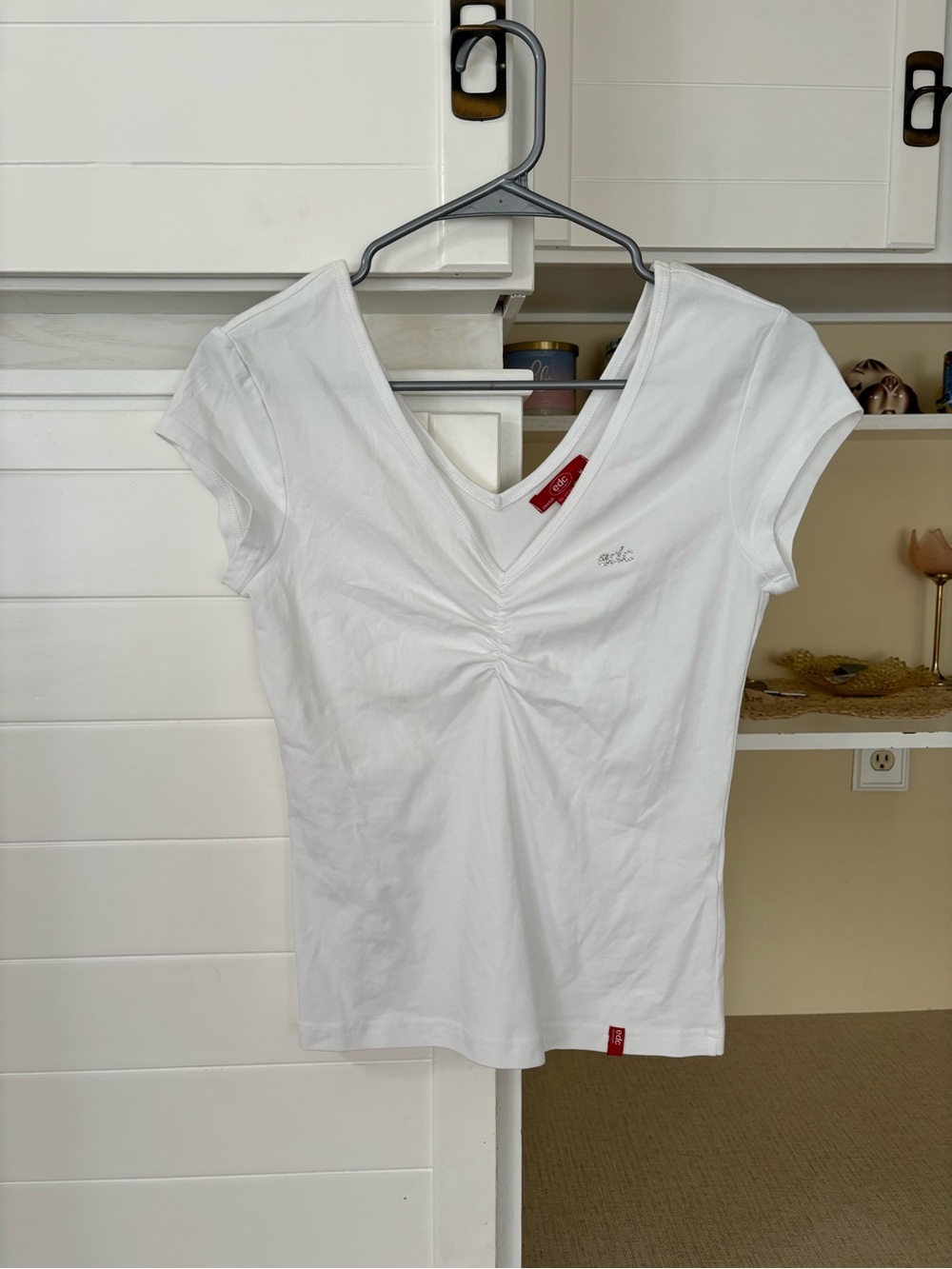 White v-neck top with rhinestone logo